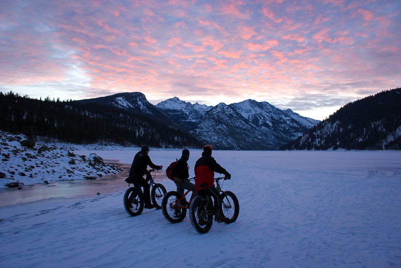 three bikers in winter at como lake montana